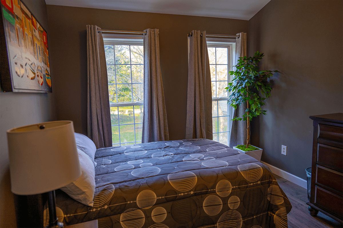 A bedroom with a patterned bedspread at the Arnold home