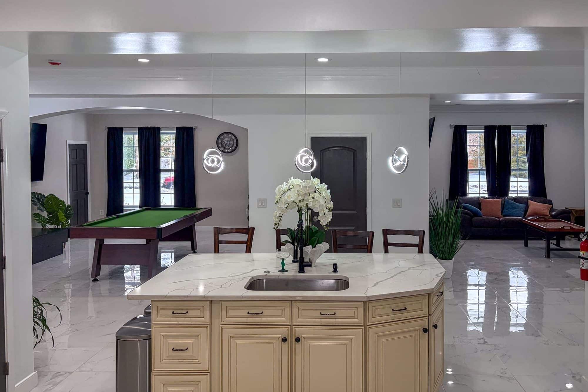 The kitchen island, with the pool table beyond, at the Alexandria home