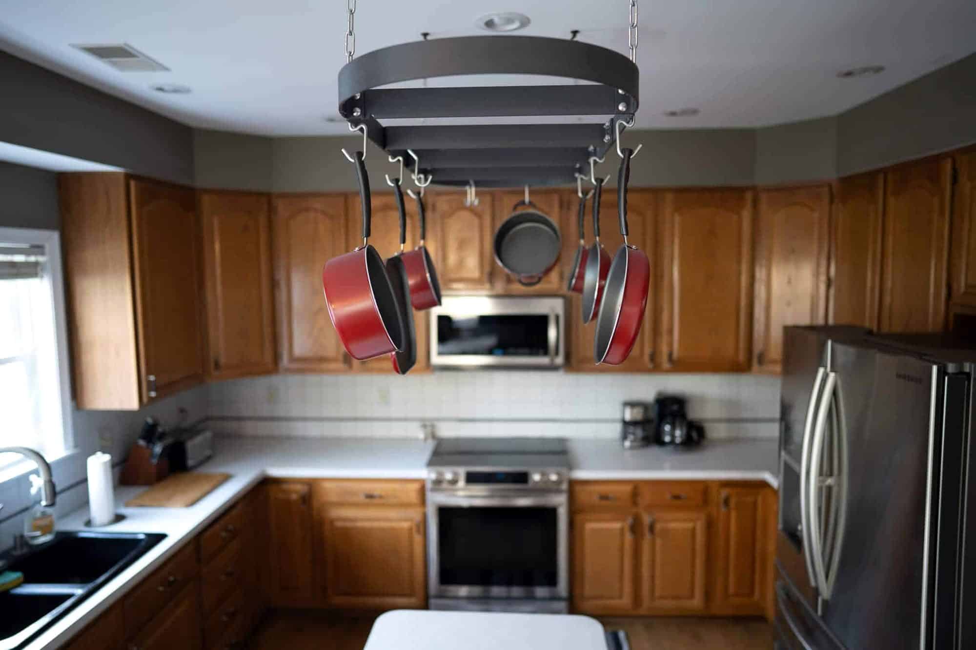 Oak cabinets and a hanging pot rack in the kitchen at the Arnold home