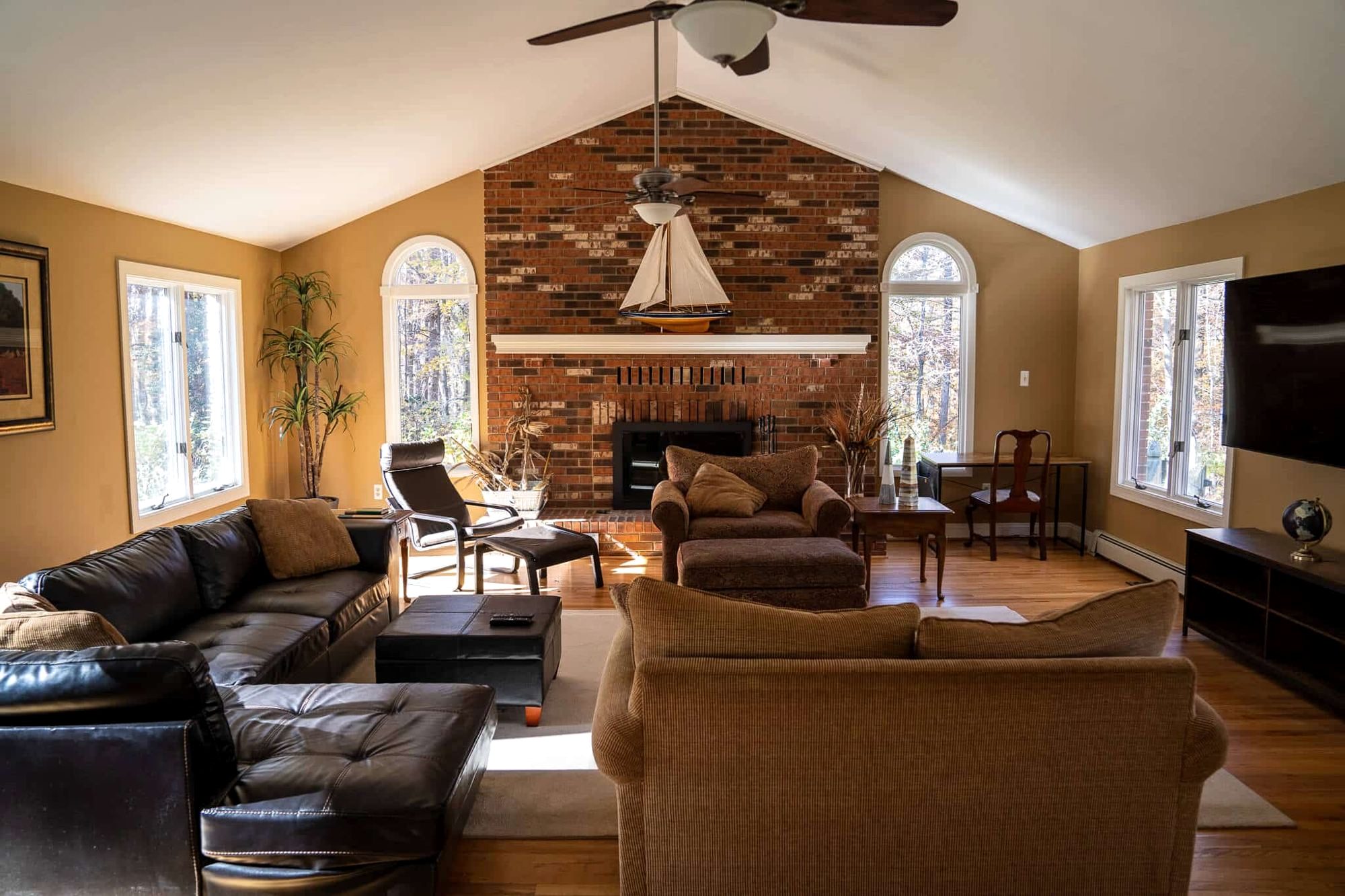 The living room with a brick fireplace at the Crownsville house