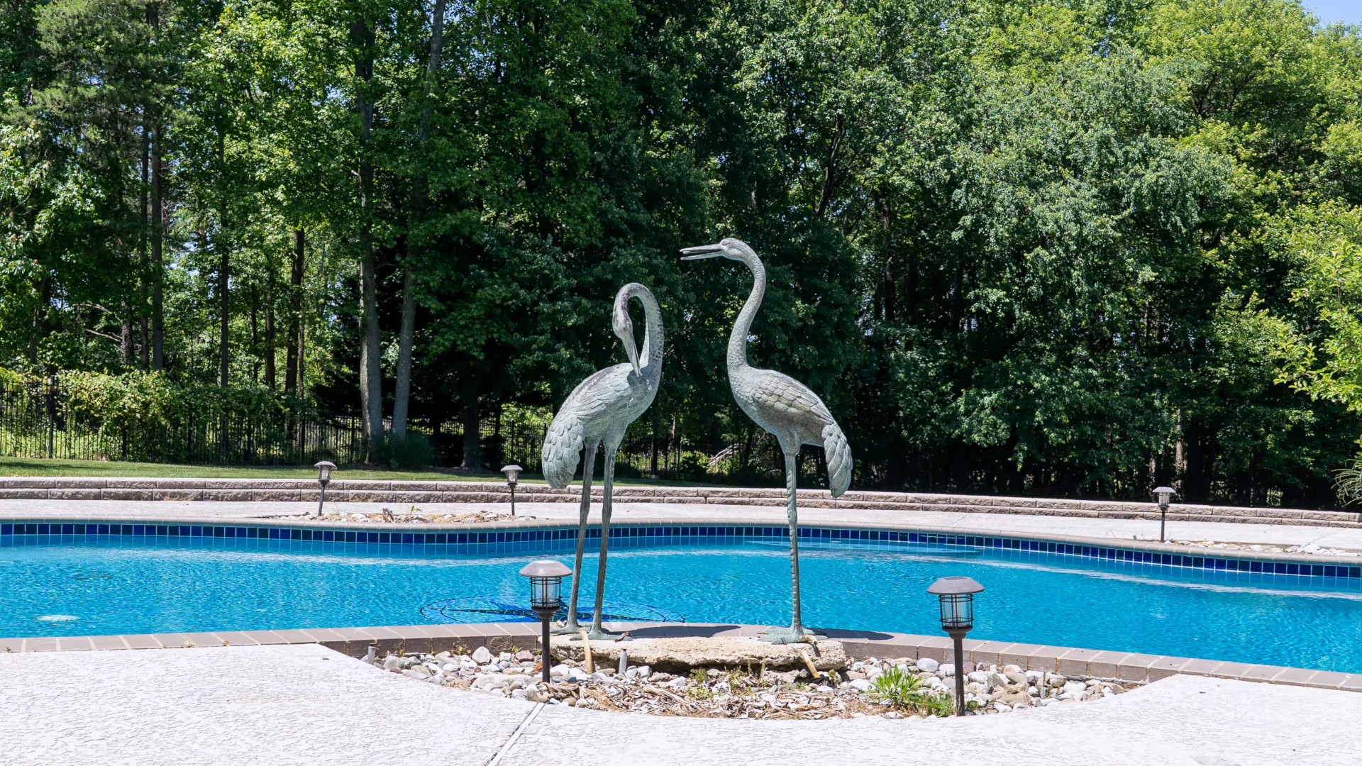 29 seconds at the Pasadena house, in photographs: the pool and its heron statues, the shingled gazebo, the deck and a bedroom. With sound.