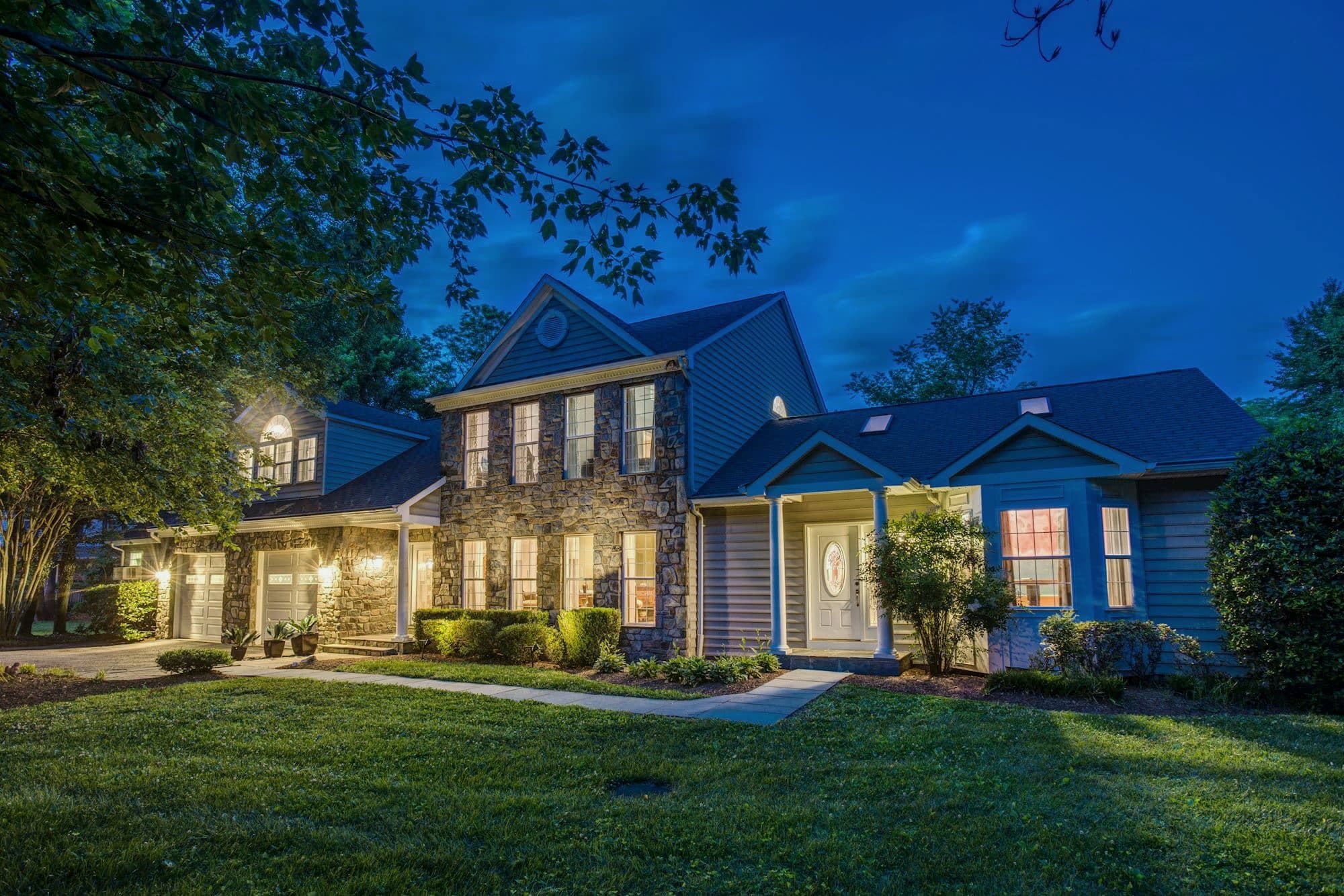 The Arnold house at dusk, its windows lit
